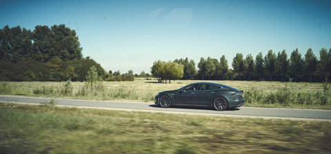 Modern,Tesla,Driving,On,A,Free,Green,Road.,Electric,Car